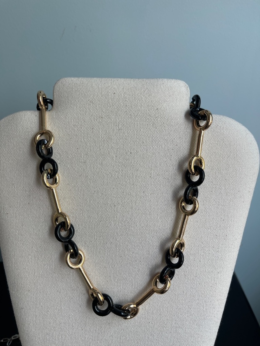 Necklace mixed chain necklace features alternating black and gold-colored